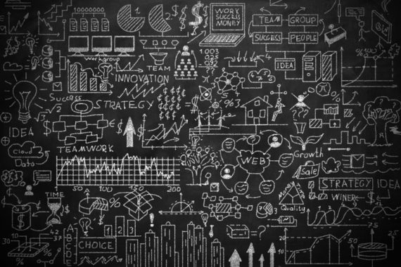 A chalkboard filled with various hand-drawn diagrams