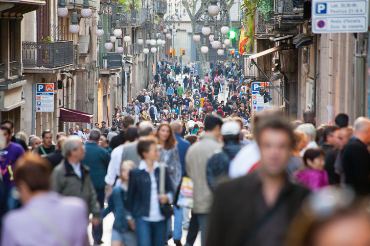 Barcelona, Spain - October 22, 2011: People, many of them tourists, walking down Carrer Ferran, which runs from Plaça Sant Jaume (where the town hall is located) to the popular "Rambles" of Barcelona.